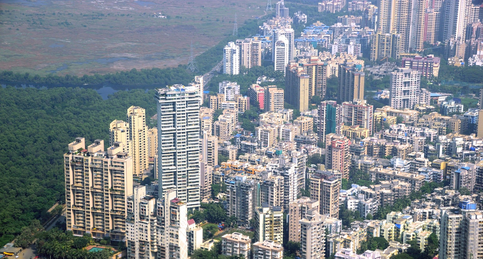 Panoramic aerial view of foggy, polluted, crowded extended suburbs of Navi Mumbai (New Bombay)